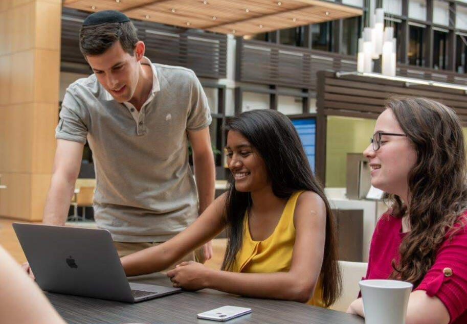 Photo of Jeyashree and two others looking at a computer